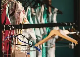 A collection of elegant dresses hanging on a clothes rack in a stylish wardrobe setup.
